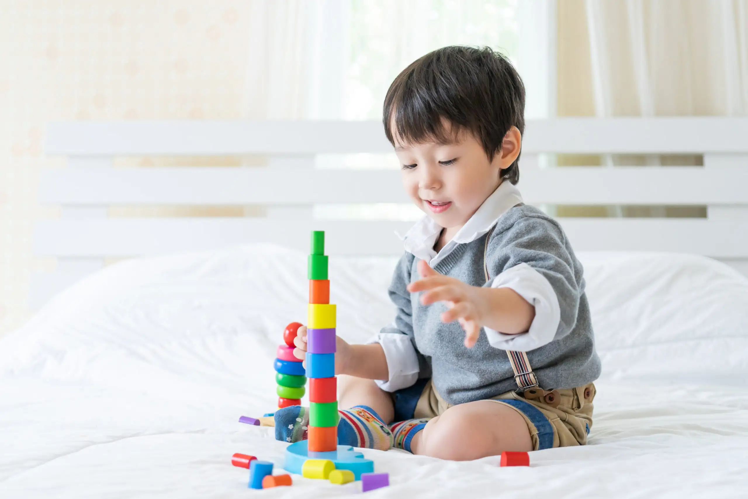 little-boy-joyful-with-colorful-wooden-learning-toy-scaled_691d84e7269ee little-boy-joyful